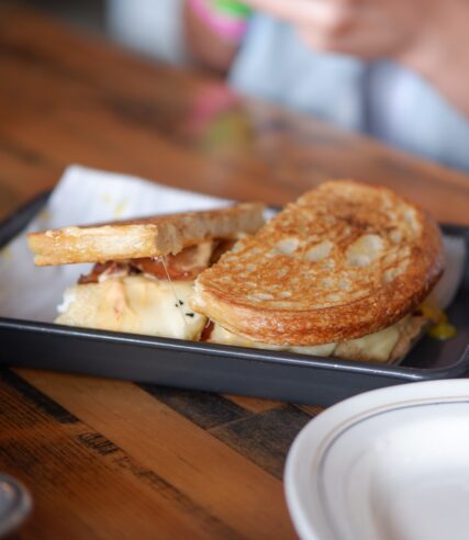 On the table, a grilled cheese sandwich is ready to enjoy.